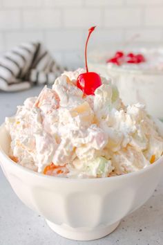 A bowl of ambrosia salad featuring pineapple, mandarin oranges, coconut, rainbow marshmallows, and a creamy dressing, topped with a bright red cherry for garnish. Cherry Fluff Salad, Favorite Deserts, Dessert Salad Recipes, Cherry Fluff, Fluff Salad Recipes, Fluff Salad, Fluff Recipe, Fluff Desserts, Creamy Dressing