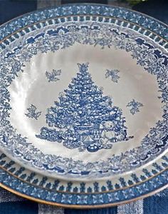 a blue and white plate with a christmas tree on it