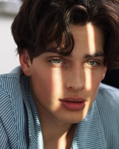 a young man with brown hair and green eyes