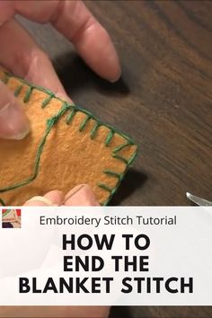 someone is stitching on the edge of a piece of fabric to make a blanket