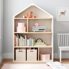 a child's book shelf with books and toys