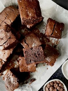 some brownies are cut up and ready to be eaten with chocolate chips on the side