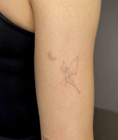 a woman's arm with a small tattoo on the left side of her body