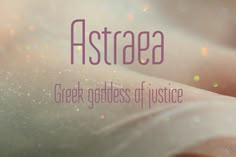 the words astraea are written in purple and pink on a blurry background