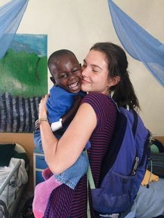 a woman holding a small child in her arms