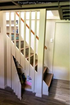 stairs leading to the second floor in a house with wood floors and white railings