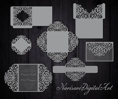 an assortment of laser cut wedding cards and envelopes on a wooden background with space for text