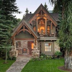 a large house with lots of windows on the front and side of it, surrounded by trees