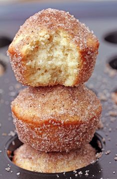 two sugared donuts stacked on top of each other in a muffin tin