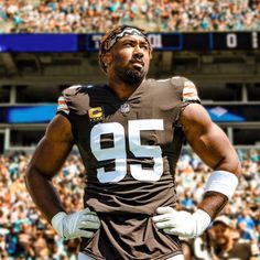 a football player standing in front of a crowd