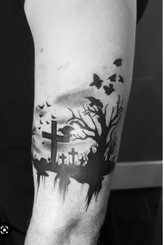 a person with a tattoo on their arm that has an image of animals and trees