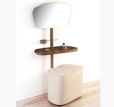 a white stool sitting next to a mirror