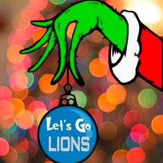 a christmas ornament with the grin's head hanging from it, and let's go lions