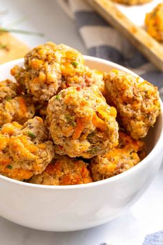 a white bowl filled with meatballs on top of a table