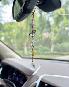 a car dashboard with a necklace hanging from the dash board