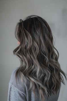 Save this pin for a stunning long wavy brunette with ash grey highlights! Feeling bored with your current hair color? Tap to see how these gorgeous highlights can add depth and dimension to your look, making you feel fabulous! Dark Brunette Balayage Hair Ashy, Grey Hair Color Ideas For Brunettes, Grey Brown Hair Balayage, Adding Dimension To Dark Brown Hair, Icy Babylights, Ash Grey Balayage Brunettes, Ash Colored Hair, Smoky Brunette Hair, Frosty Brunette Hair