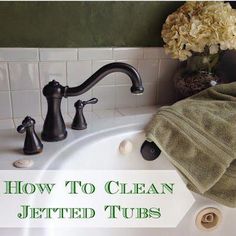 a bathroom sink with towels on it and flowers in the bowl next to it that says how to clean jettted tubs