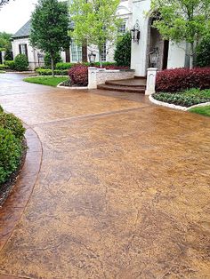 a driveway that has been cleaned and is in front of a house