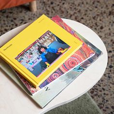 a stack of books sitting on top of a white table