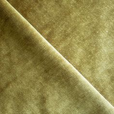 a close up view of a green velvet fabric