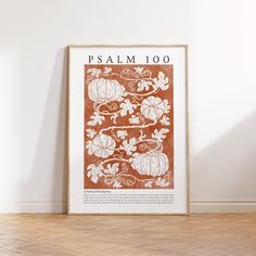 an orange and white poster with pumpkins on it sitting in front of a wall