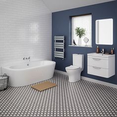 a bathroom with blue walls and white fixtures