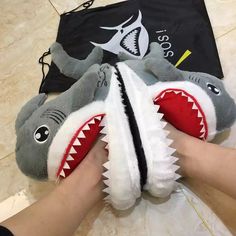 CUTE SHARK DESIGN: Decorated with a Shark, this pair of slippers looks really cute. You'll feel happy when seeing the adorable slippers when coming back home. A day's tiredness will be reduced soon. COMFORTABLE AND SOFT: The slippers are made with high quality 1”thick foam footbeds, soft polyester plush, and terrycloth details. Soft plush slipper will keep your toes warm. This style of slipper is anti-slip designed, you do not need to worry about slipping in the living room. Solid high density m Shark Funny, Shark Slides, Friends Christmas Gifts, Shark Shoes, Wide Set Eyes, Fun Slippers, Cool Sharks, Funny Shoes, Cat Slippers