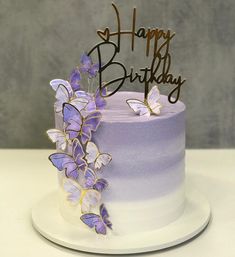 a purple and white cake with butterflies on it