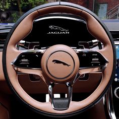 the interior of a car with an automatic steering wheel and tan leather dash cover,