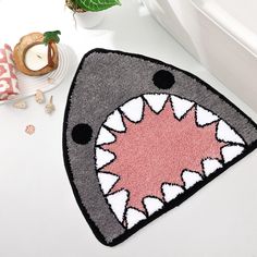 a bathroom rug with a shark's mouth on it