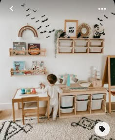 a young child playing with toys in a playroom area that includes shelves, bins and toy cars