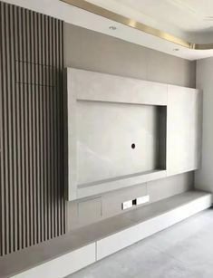 an empty room with a wall mounted tv