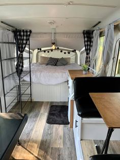 the interior of a camper with a bed and desk