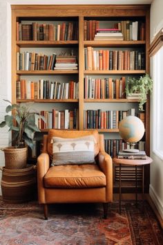 a living room filled with lots of books on top of a wooden shelf next to a window