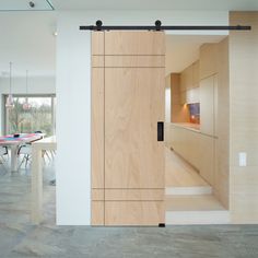 an open door leading to a dining room with table and chairs in the back ground