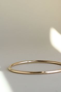 The Georgia Bangle is modern yet timeless—a minimalist bracelet featuring an organic oval shape, designed for constant wear. It is comfortable enough for sleep and sport, and strong enough to gracefully withstand decades of daily use. Each hand-soldered bracelet is shaped to mimic the contours of your forearm. Available in durable 14k gold fill, solid sterling silver, and solid 14k or 18k gold, these materials are solid (not hollow), water-resistant, and low maintenance. This bangle is truly mad Soldered Bracelet, Simple Gold Bangle, Ribbon Ring, Instagram Jewelry, Simple Organic, Bracelet Style, Jewelry Style, Minimalist Bracelet, Gold Bangle Bracelet