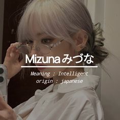 a woman holding a cell phone up to her face with the words mizuna on it