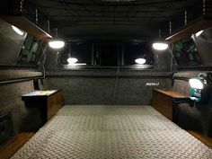 the inside of a vehicle with two lights on and no bed in front of it