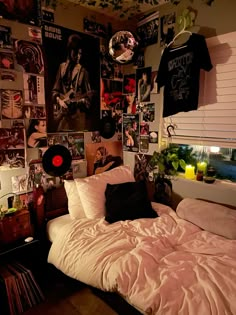 a bedroom with pictures on the wall and a bed in it's centerpiece