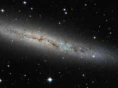 an image of the andromidus galaxy with stars in the sky behind it