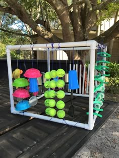 tennis balls and rackets are hung on the back of a truck in front of a tree