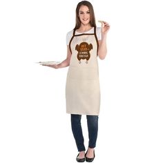 a woman in an apron holding a plate with food on it