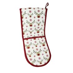 an oven mitt with red trim and white flowers on the front, hanging from a hook