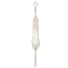 a white kitchen utensil hanging from a hook on a wall in front of a white background