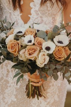 a bride holding a bouquet of flowers in her hands