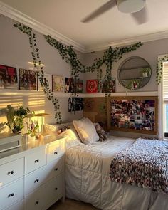 a bedroom with plants growing on the wall above the bed and below the bed is a dresser