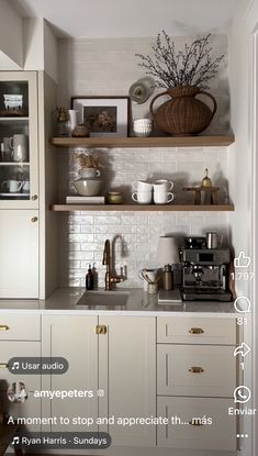 a white kitchen with open shelving above the sink and counter tops, along with an oven