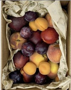 a box filled with lots of different types of fruit