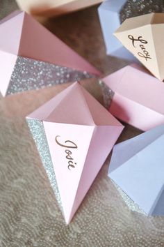 pink and blue paper cones with the word care written on them sitting on a table