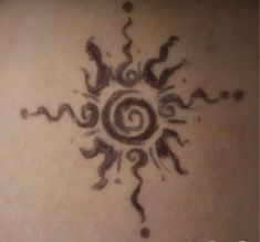 an artistic tattoo design on the back of a woman's upper arm and shoulder